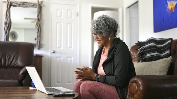 Pretty black lady with grey hair on a video consultation with her doctor discussing bleeding after sex during menopause