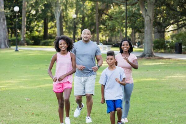 Family of African background outdoors one example of cardio exercises