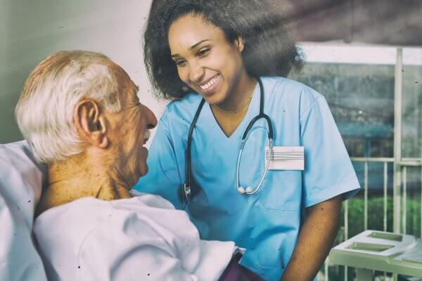 Doctor smiling with an elderly patient insight can depend on stage of dementia