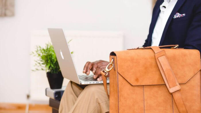 Gentleman in formal clothing typing on a laptop - men need to know about Prostate Cancer
