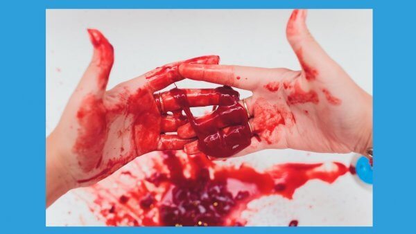 Hands covered in blood that can happen in postcoital bleeding