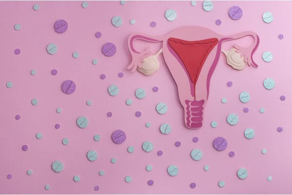 Image of the womb on a pink background with pills around it depicting Postinor1 and Post Pill