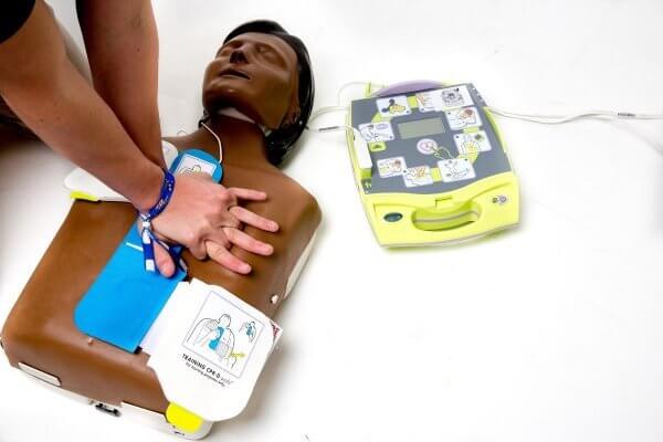 Practicing CPR with AED and dummy
