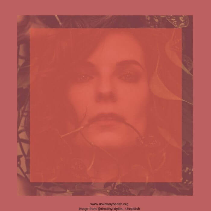 Hazy image of a woman's face with tendrils around her face