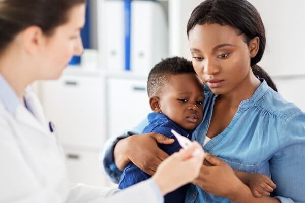 Mum holding her baby with fever from Streptococcus Group A 