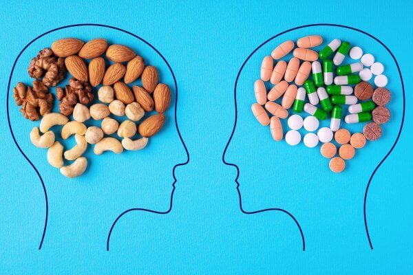 Supplements can help brain function image of 2 people with nuts brain shape and pills brain shape on blue background