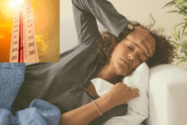 African lady with hand on her forehead suffering from fever