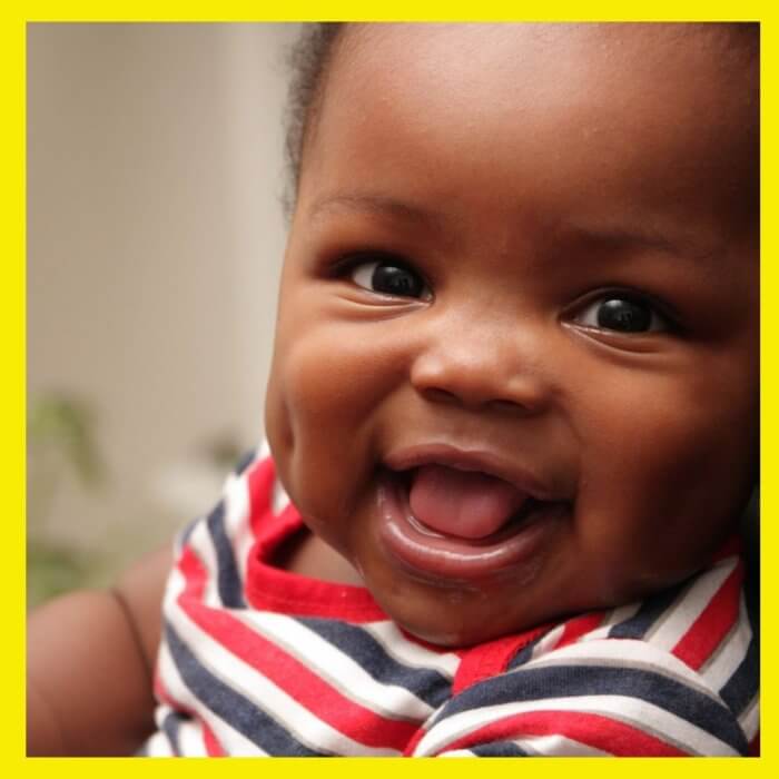 Young baby smiling with open mouth - oral yeast infections are common in babies