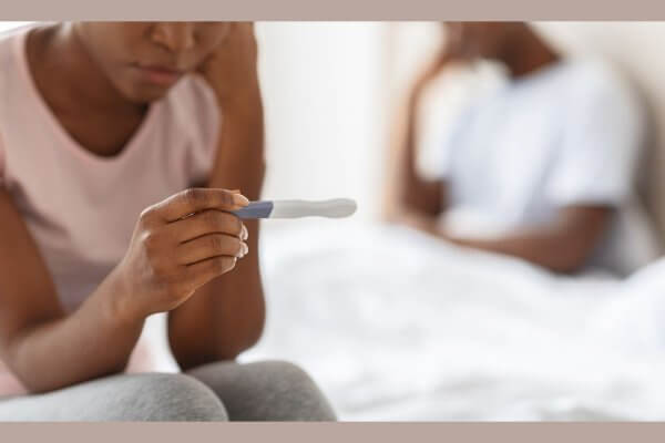Young couple upset at a positive test result, age is a cause of high risk pregnancy