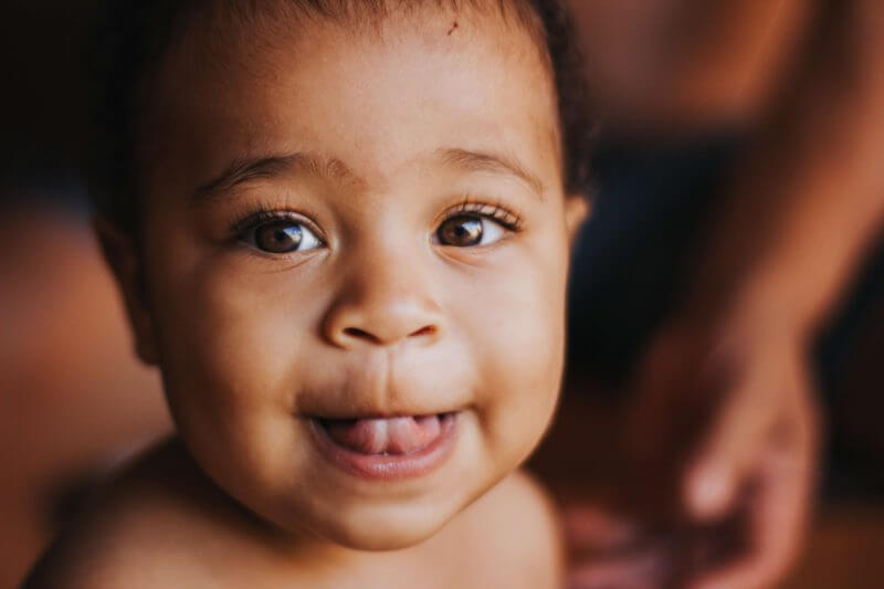 Photo of smiling baby of african background - preimplantation genetic diagnosis process could mean a health life for him.