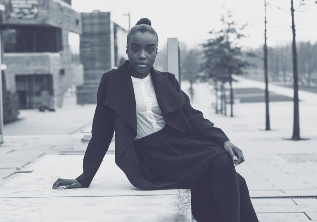 Black and White photo of sophisticated lady of African origin in black trouser suit and white blouse - Menopause symptoms and treatments