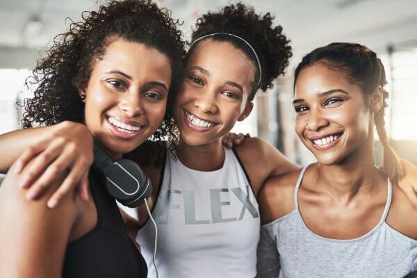 3 fit looking African ladies looking happy after their heated workouts