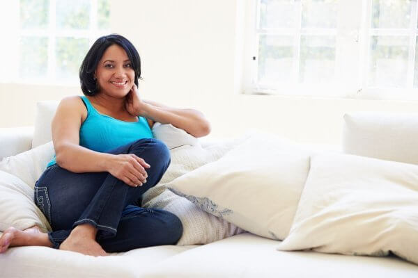 lose weight - pretty lady in blue camisole top and jeans smiling at the camera