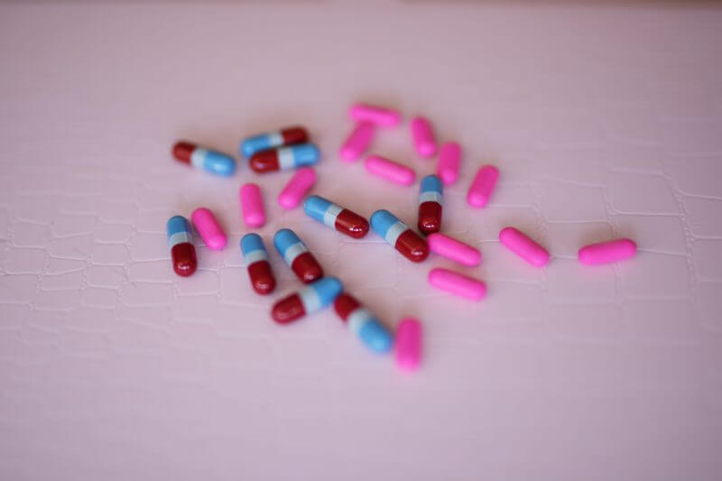 Self-diagnosis a closter of different coloured drug capsules.